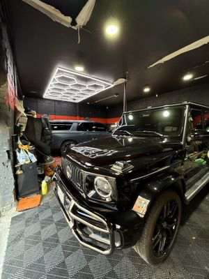 Black Mercedes G-Wagon under hex lighting